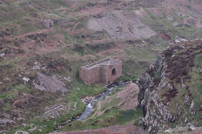 The lower Kenidjack Valley, St Just showing the granite water wheel pit and mine dumps. Surface rock here is mostly killas (slate) while the dumps are granite brought from underground blow the killas